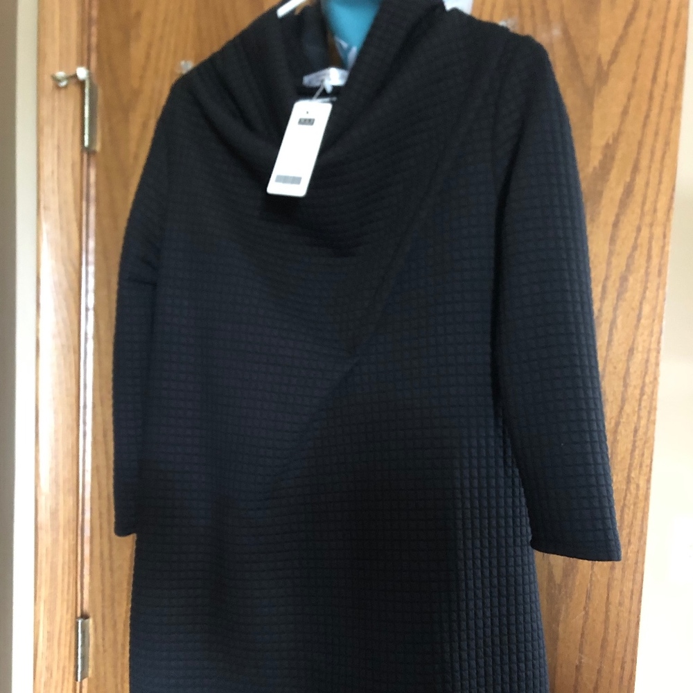 This is a pull over black waffle knit jacket